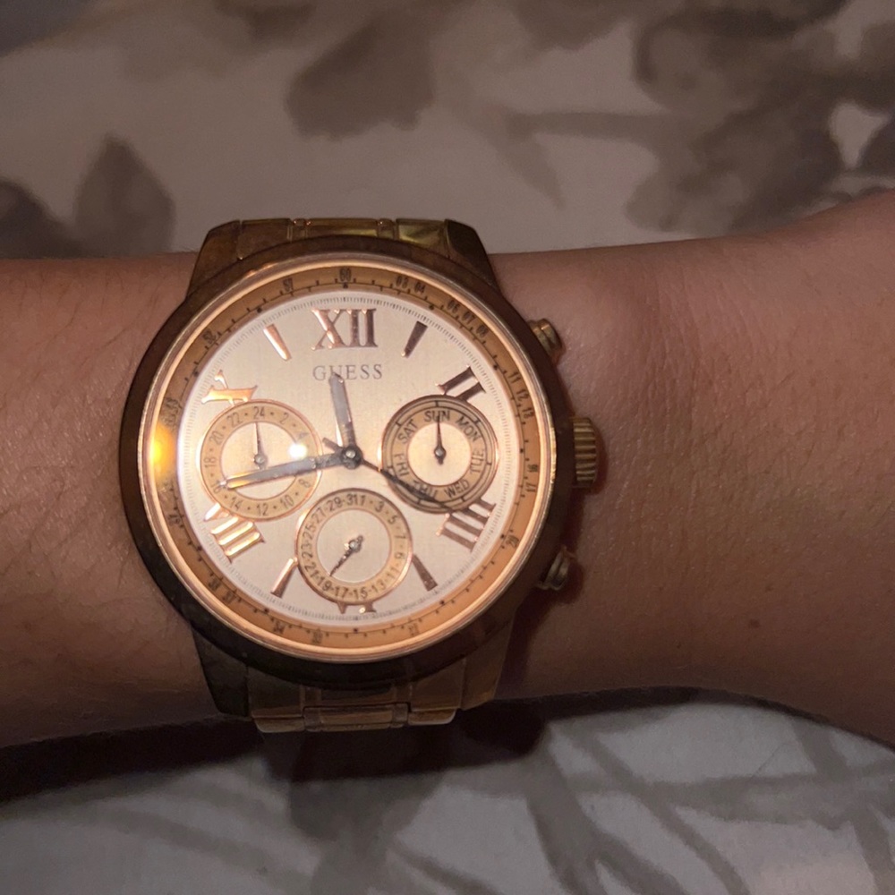 Rose gold Guess women’s watch - thick band and wide face.